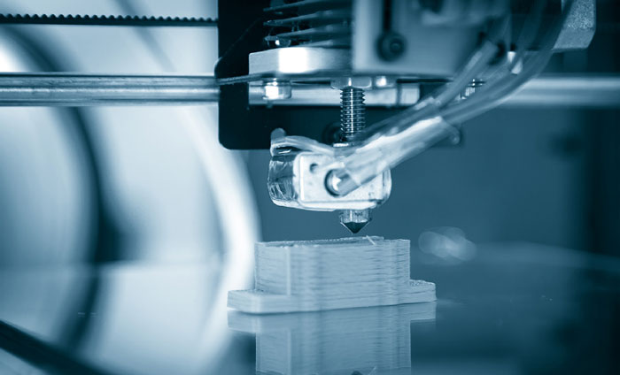 Figure 2: An example of a 3-D printer creating a plastic part layer by layer.