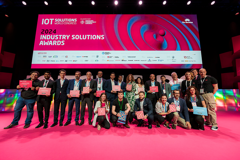 Award winners pose on stage at IOTWSC 2024.