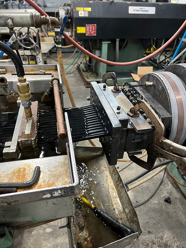 Figure 1: Typical extruder product output and water bath.