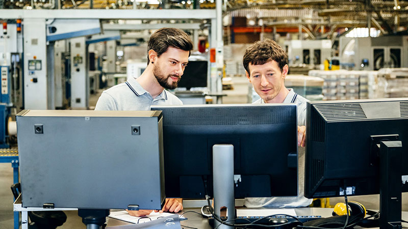 Figure 1: Engineers using software tools to increase factory productivity and efficiency.
