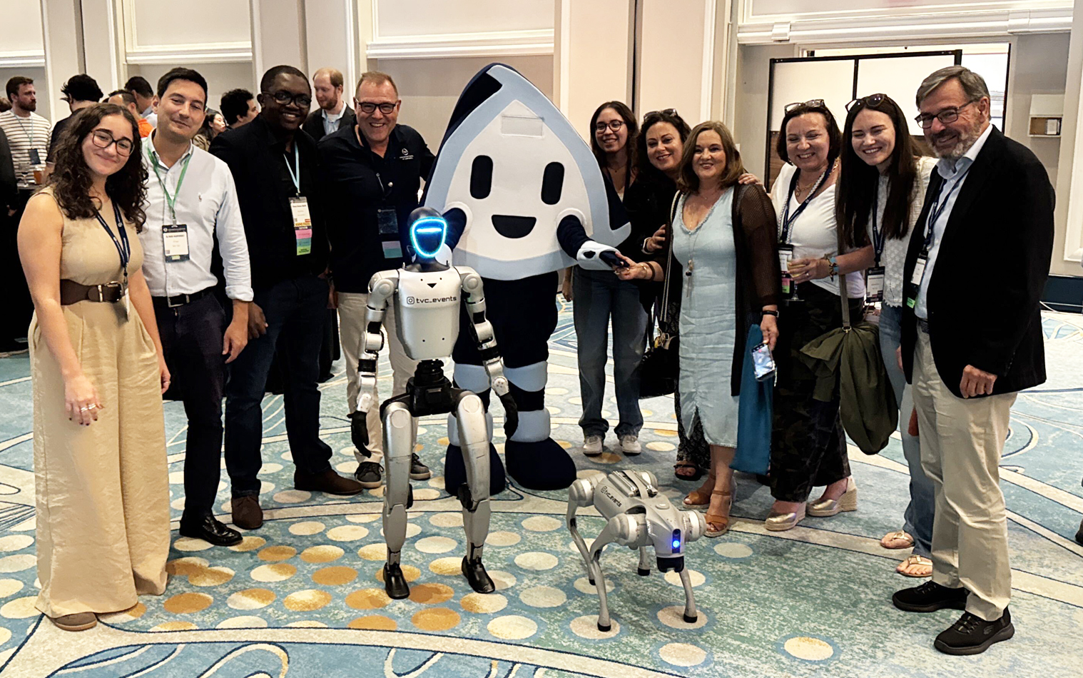 ASE attendees with Mimo and two robots from the exhibits.  